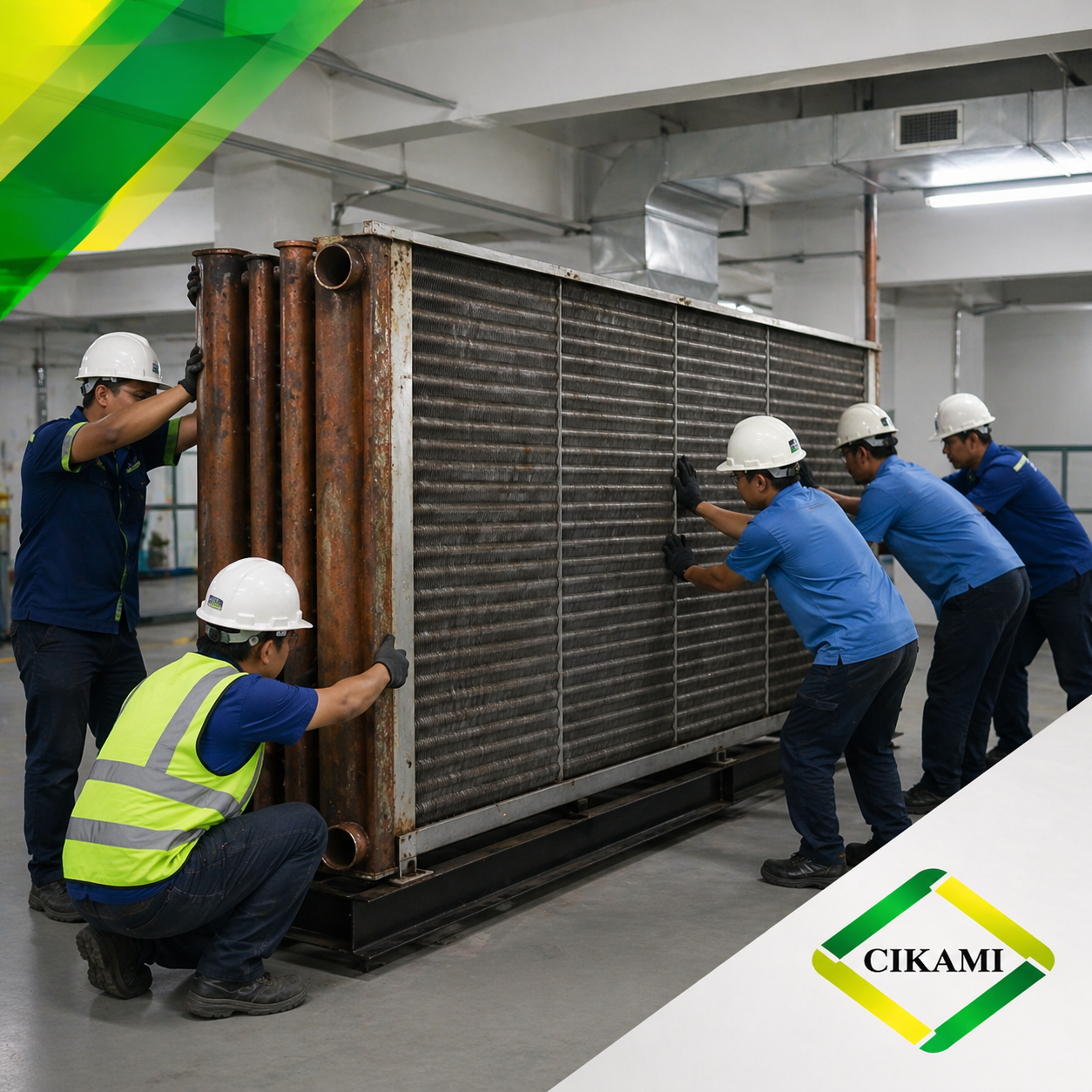 Tim teknisi melakukan penggantian cooling water coil berukuran besar pada sistem HVAC gedung